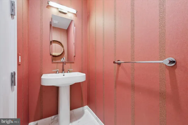 a bathroom with a sink a mirror and shower curtain