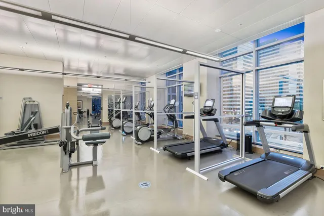 a room with gym equipment and a large window