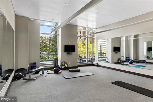 a very nice looking living room with a large window and wooden floor