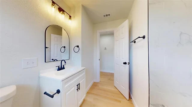 a bathroom with a double vanity sink a mirror and a shower