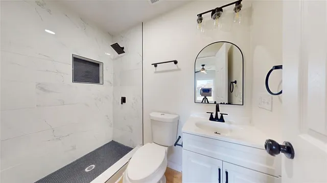 a bathroom with a sink a toilet and a mirror