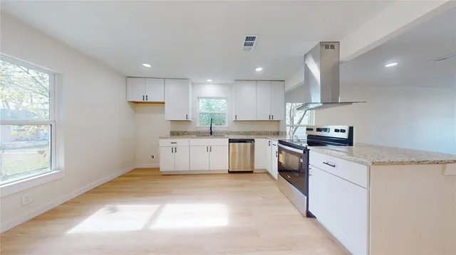 a kitchen with white cabinets and white appliances