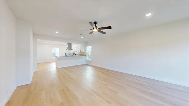 a view of a kitchen with a sink and a refrigerator