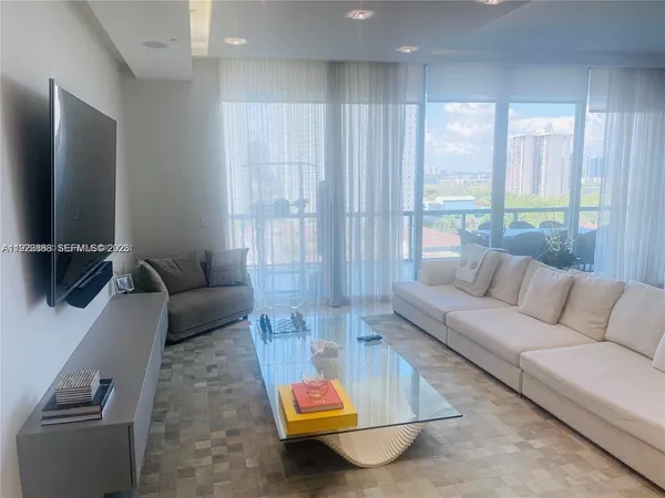 a living room with furniture and a flat screen tv