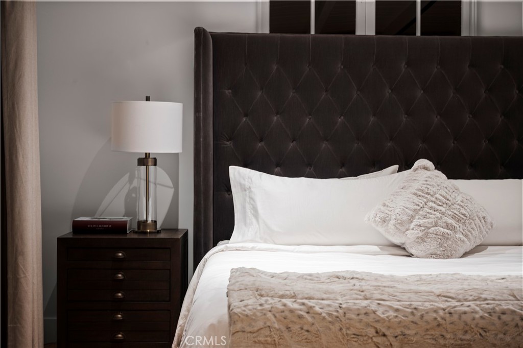 11305 Valley Spring Lane Studio City, CA 91602 - Photo 2 of 50 a bed sitting in a bedroom next to a bathroom