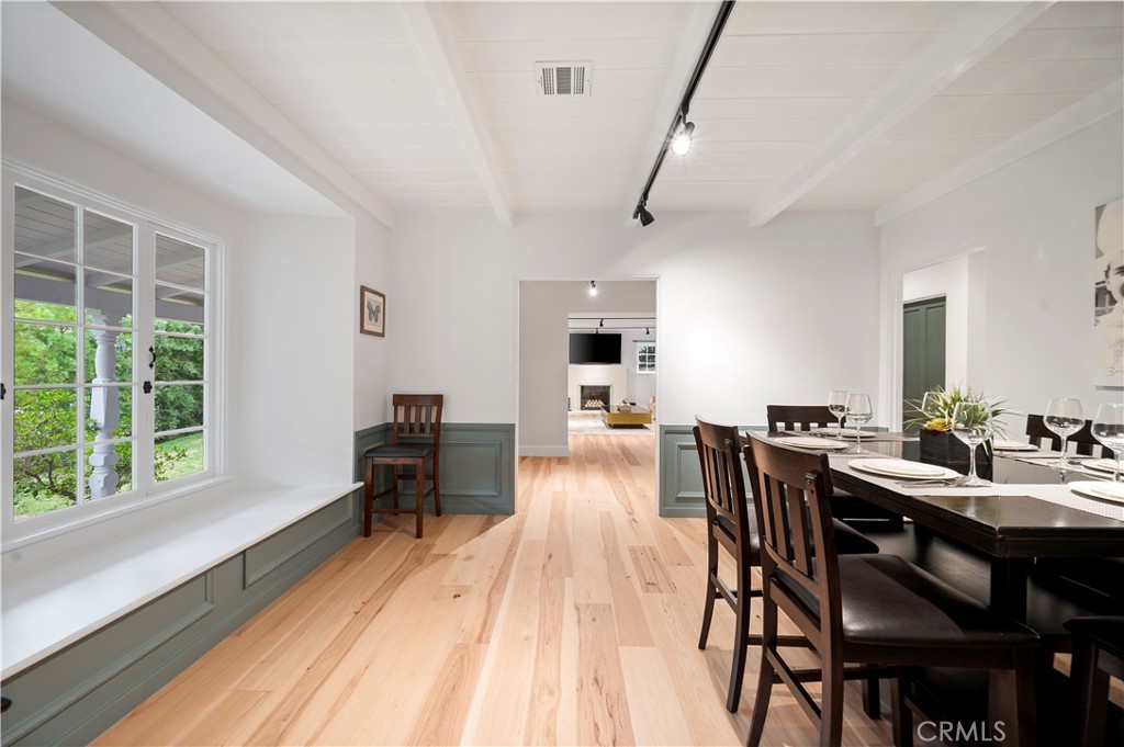 11305 Valley Spring Lane Studio City, CA 91602 - Photo 24 of 50 a view of a dining room with furniture window and wooden floor