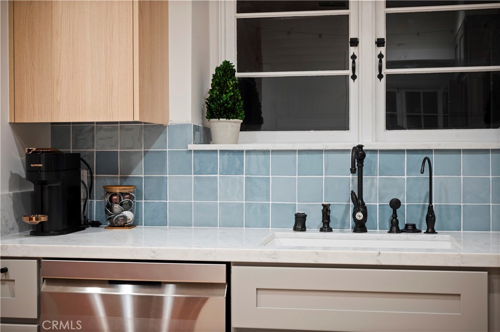 11305 Valley Spring Lane Studio City, CA 91602 - Photo 32 of 50 a kitchen with a sink and potted plant