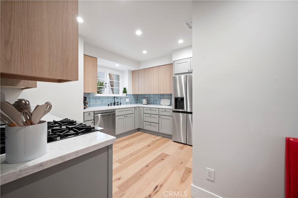 11305 Valley Spring Lane Studio City, CA 91602 - Photo 33 of 50 a kitchen with a sink stainless steel appliances and white cabinets