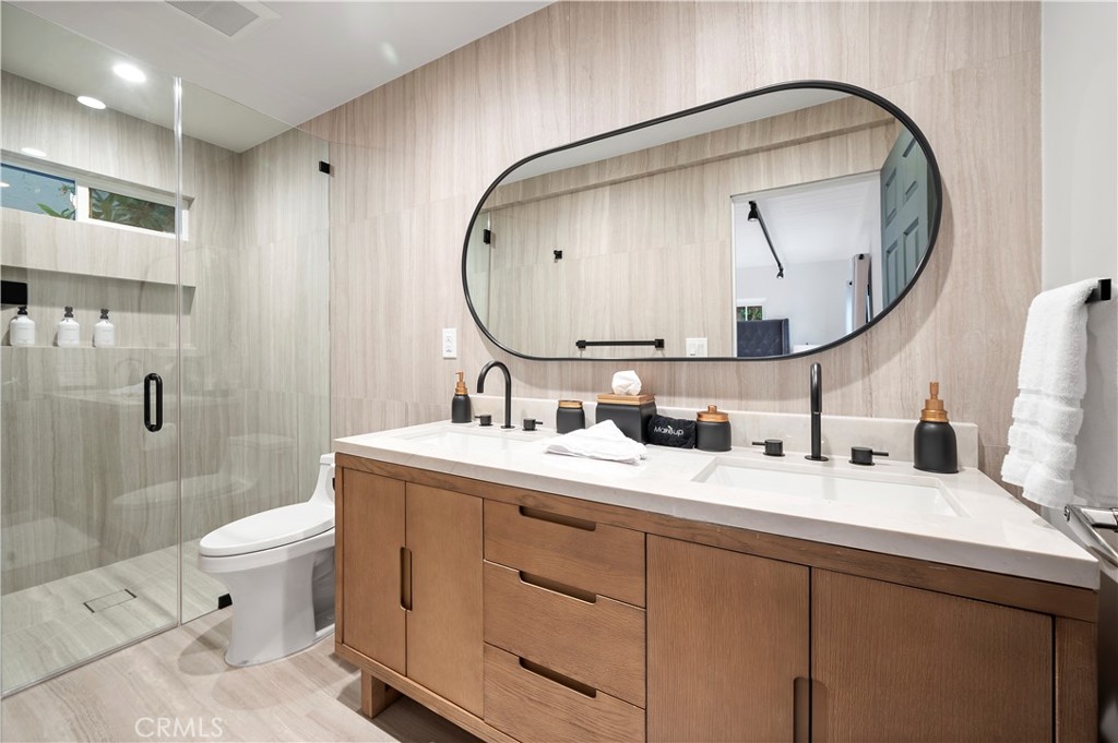 11305 Valley Spring Lane Studio City, CA 91602 - Photo 37 of 50 a bathroom with a double vanity sink mirror and toilet