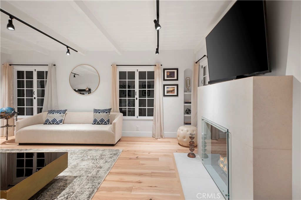 11305 Valley Spring Lane Studio City, CA 91602 - Photo 6 of 50 a living room with furniture a fireplace and a large window