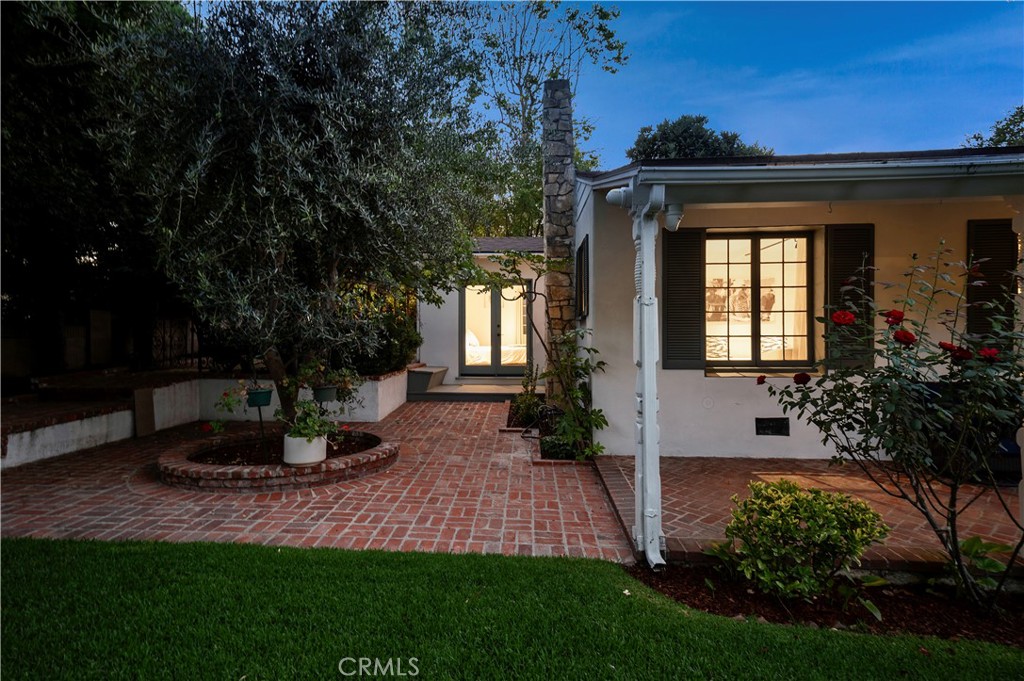 11305 Valley Spring Lane Studio City, CA 91602 - Photo 9 of 50 a view of a house with a small yard and a large tree