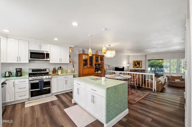 a kitchen with a sink stove and refrigerator