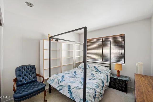 a bedroom with a bed and window