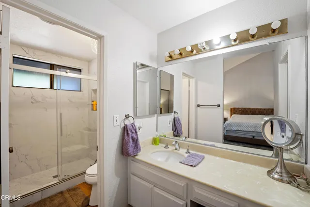 a bathroom with a sink a mirror and shower