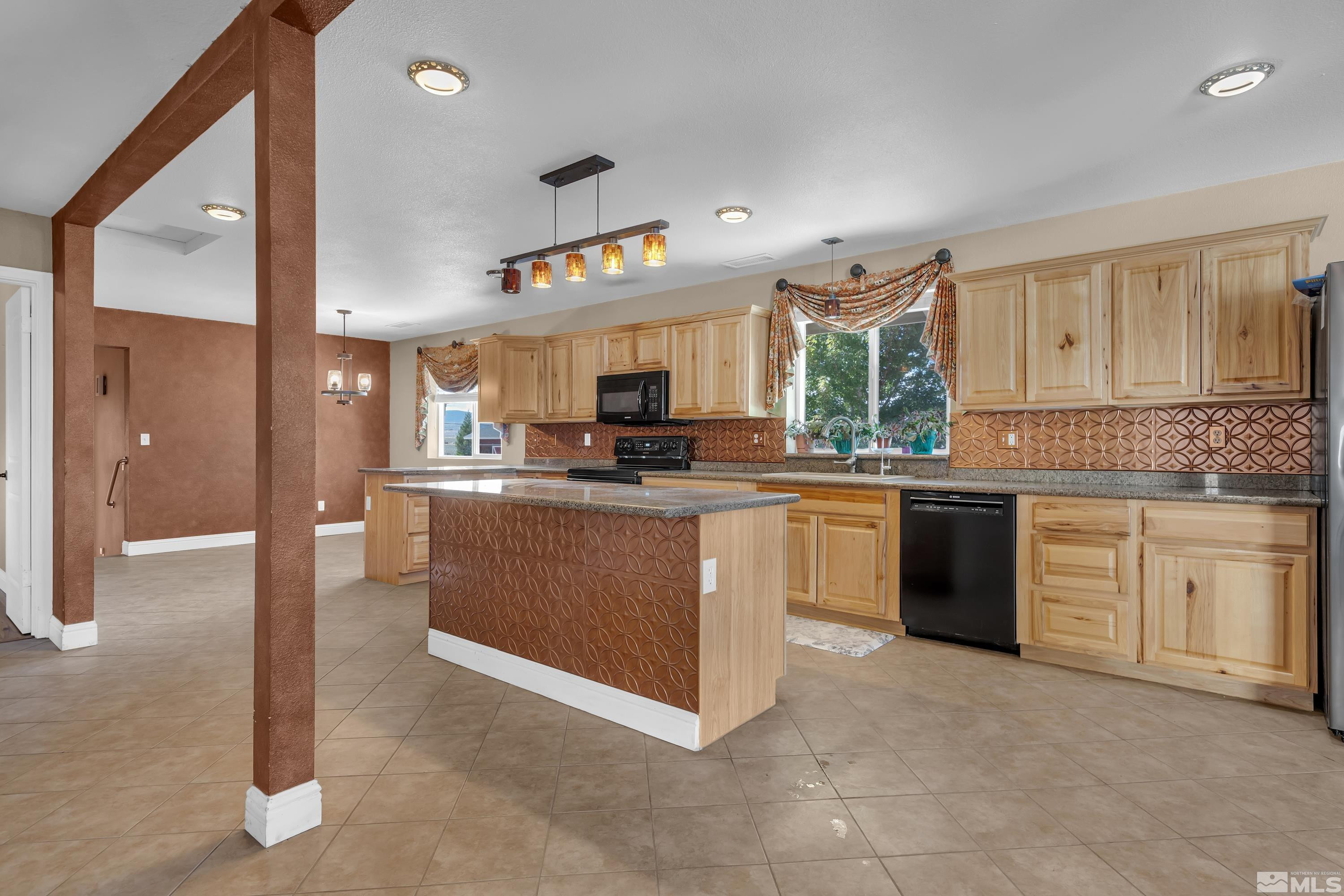 4600 Pasture View Road Reno, NV 89510 - Photo 19 of 40 a kitchen with stainless steel appliances granite countertop a stove sink and cabinets