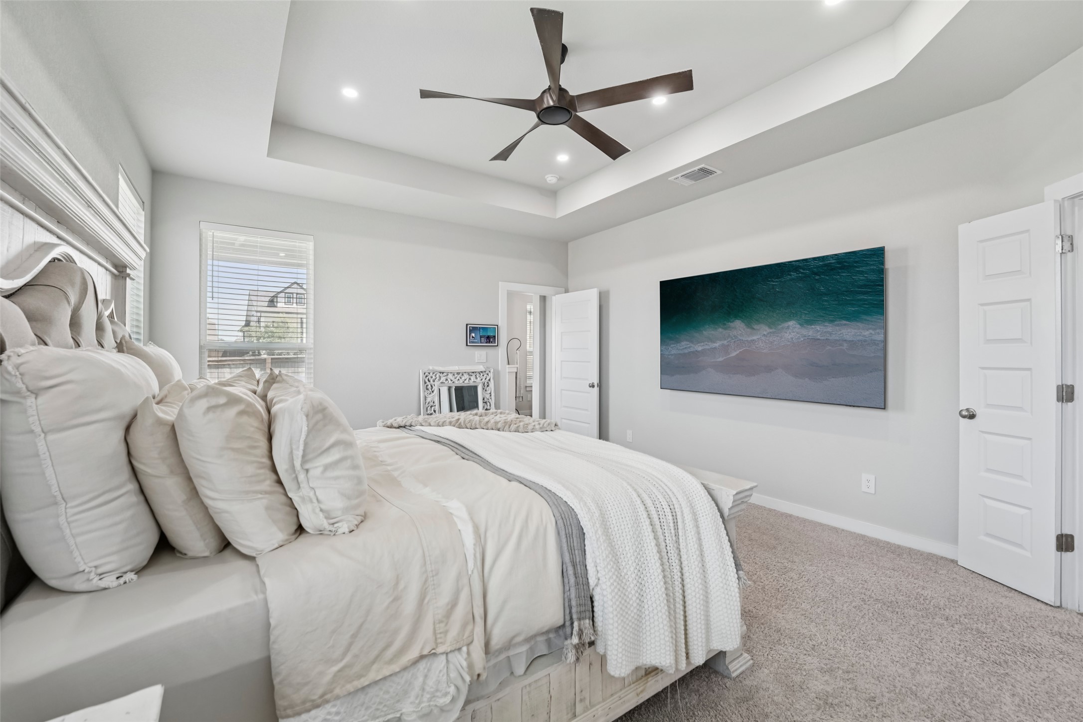1108 Sweetspire Street Leander, TX 78641 - Photo 22 of 39 Bedroom with a raised ceiling, carpet floors, recessed lighting, and a ceiling fan