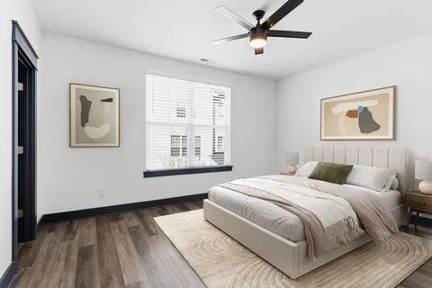 a bedroom with a large bed and a window