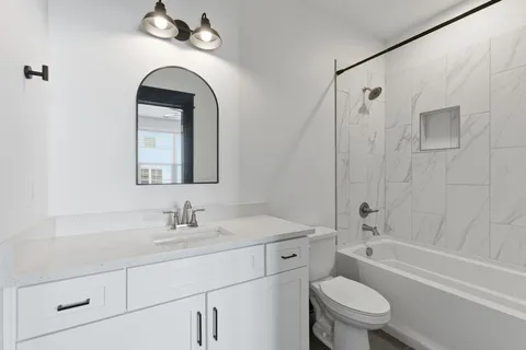 a bathroom with a toilet sink shower and bathtub