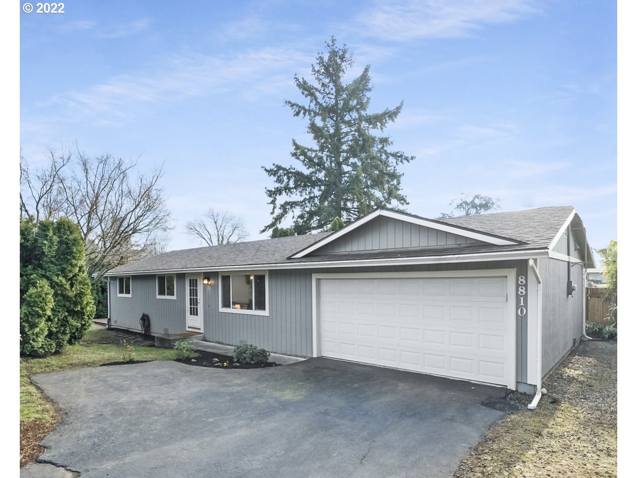 8810 Southeast Rural Street Portland, OR 97266 - Photo 1 of 32 a front view of a house with a garage