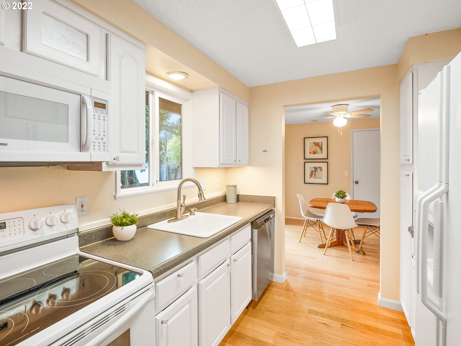 8810 Southeast Rural Street Portland, OR 97266 - Photo 11 of 32 a spacious bathroom with a granite countertop sink and a window