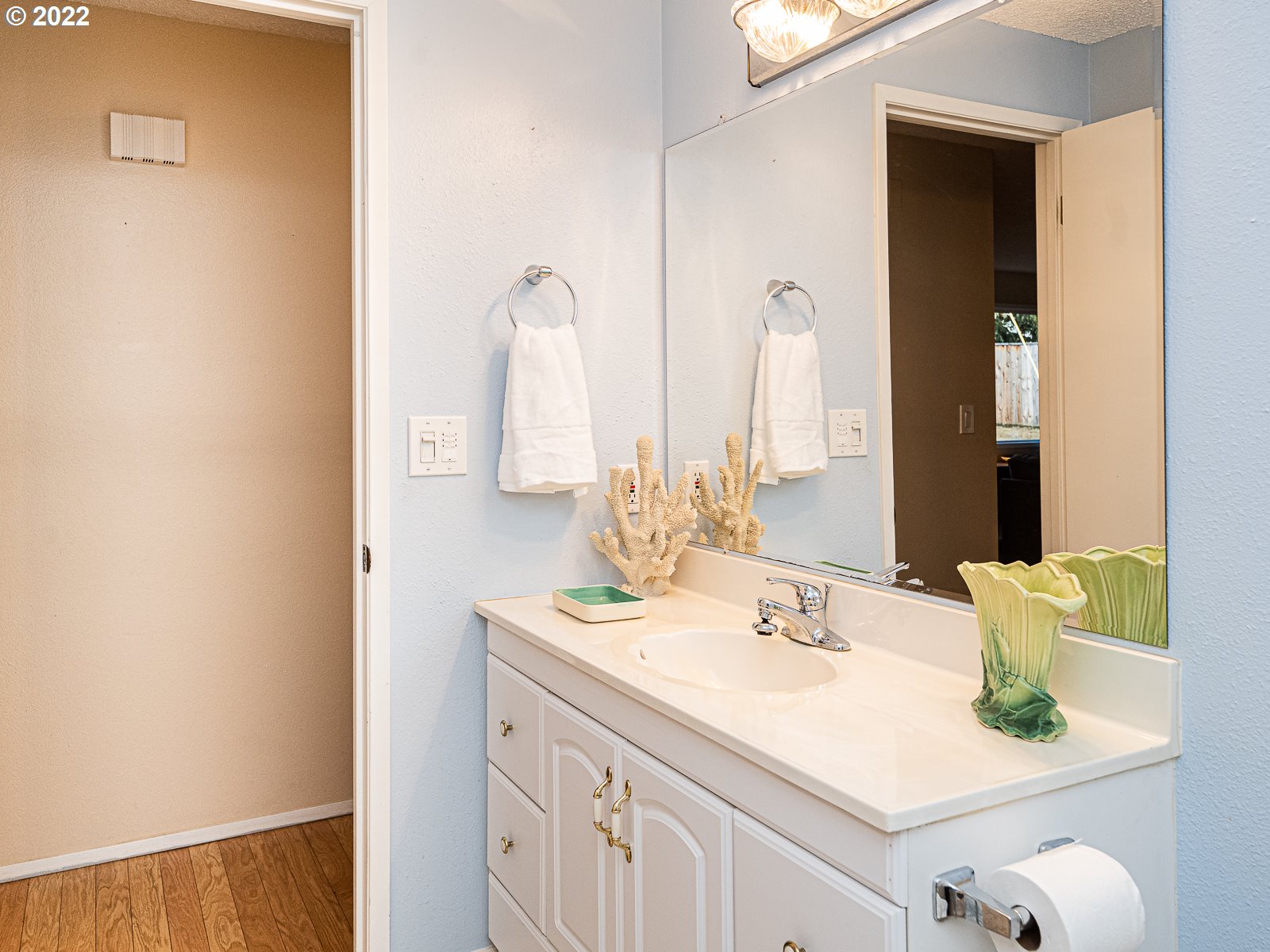 8810 Southeast Rural Street Portland, OR 97266 - Photo 15 of 32 a bathroom with a sink and a mirror