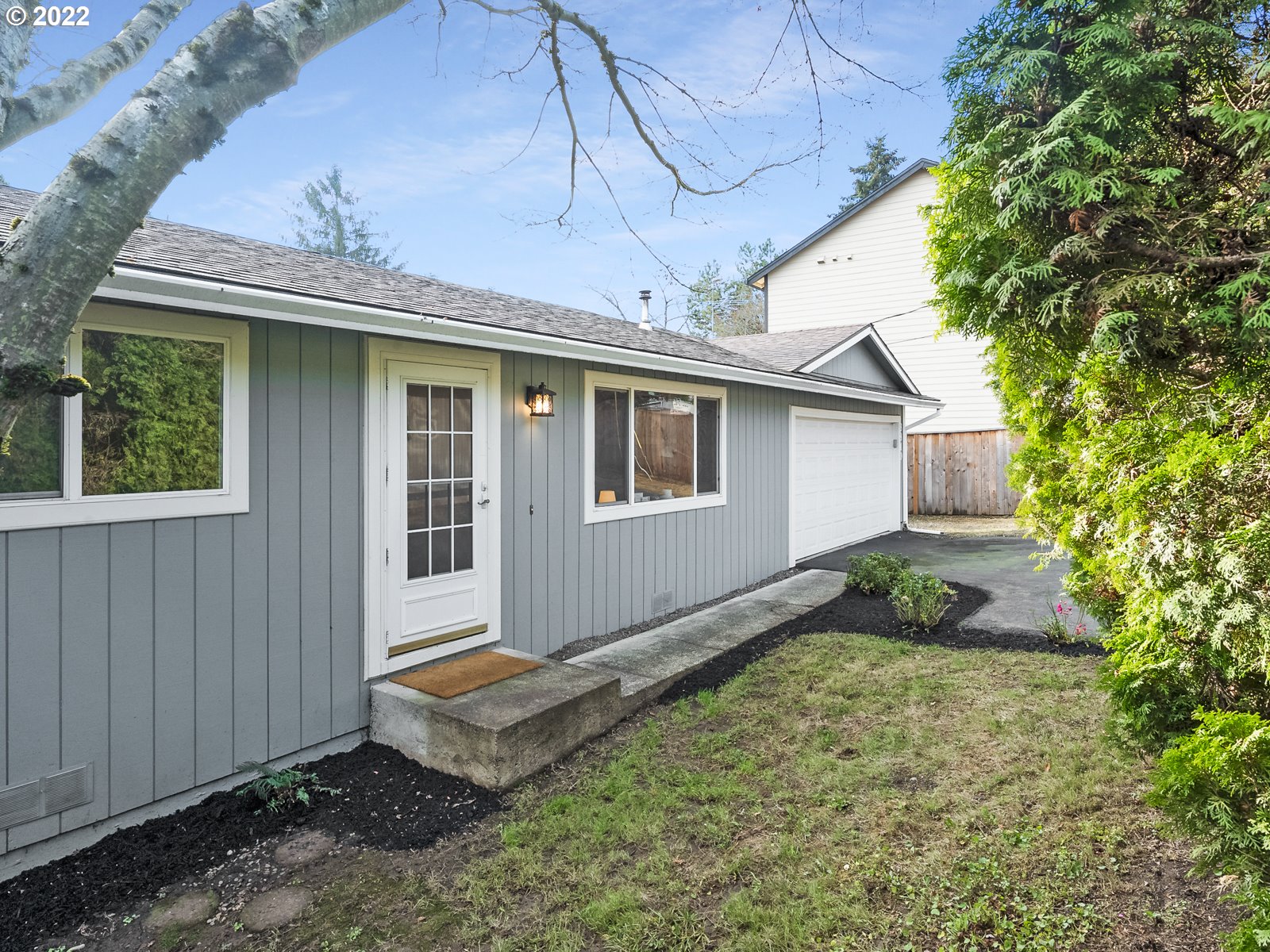 8810 Southeast Rural Street Portland, OR 97266 - Photo 2 of 32 a view of a backyard with plants and a garage
