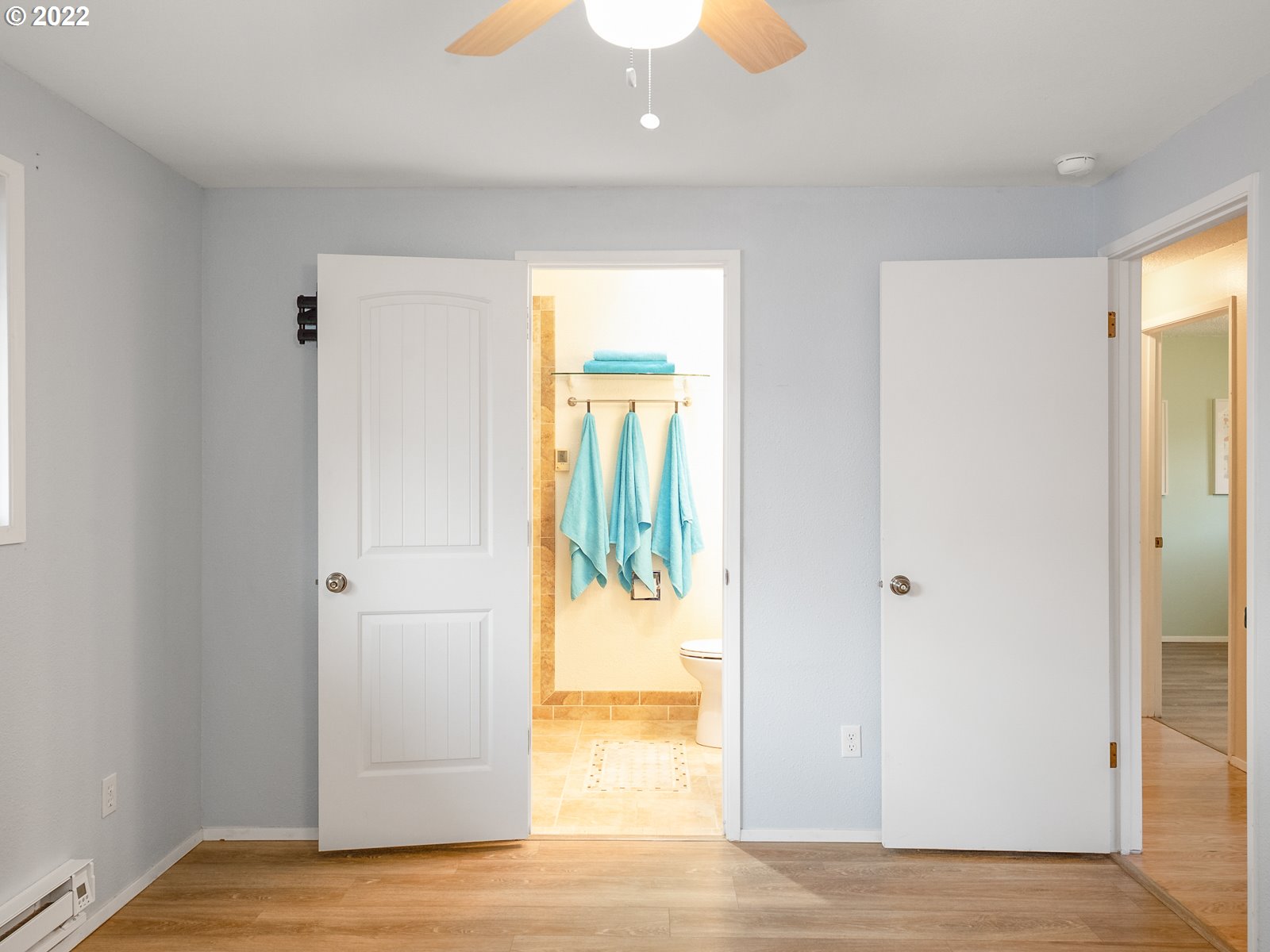 8810 Southeast Rural Street Portland, OR 97266 - Photo 21 of 32 a view of a hallway with wooden floor and a living room