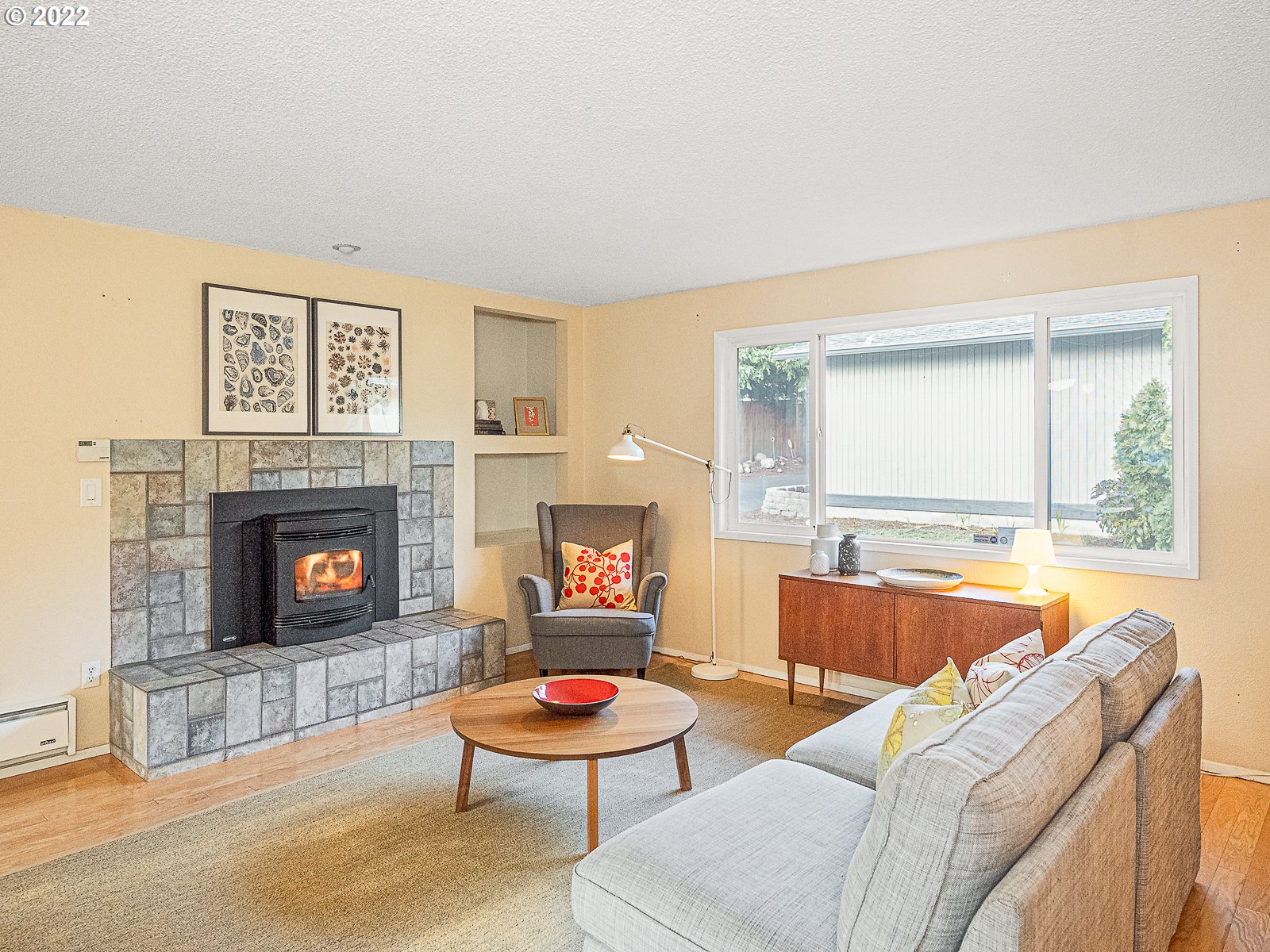 8810 Southeast Rural Street Portland, OR 97266 - Photo 4 of 32 a living room with furniture and a fireplace