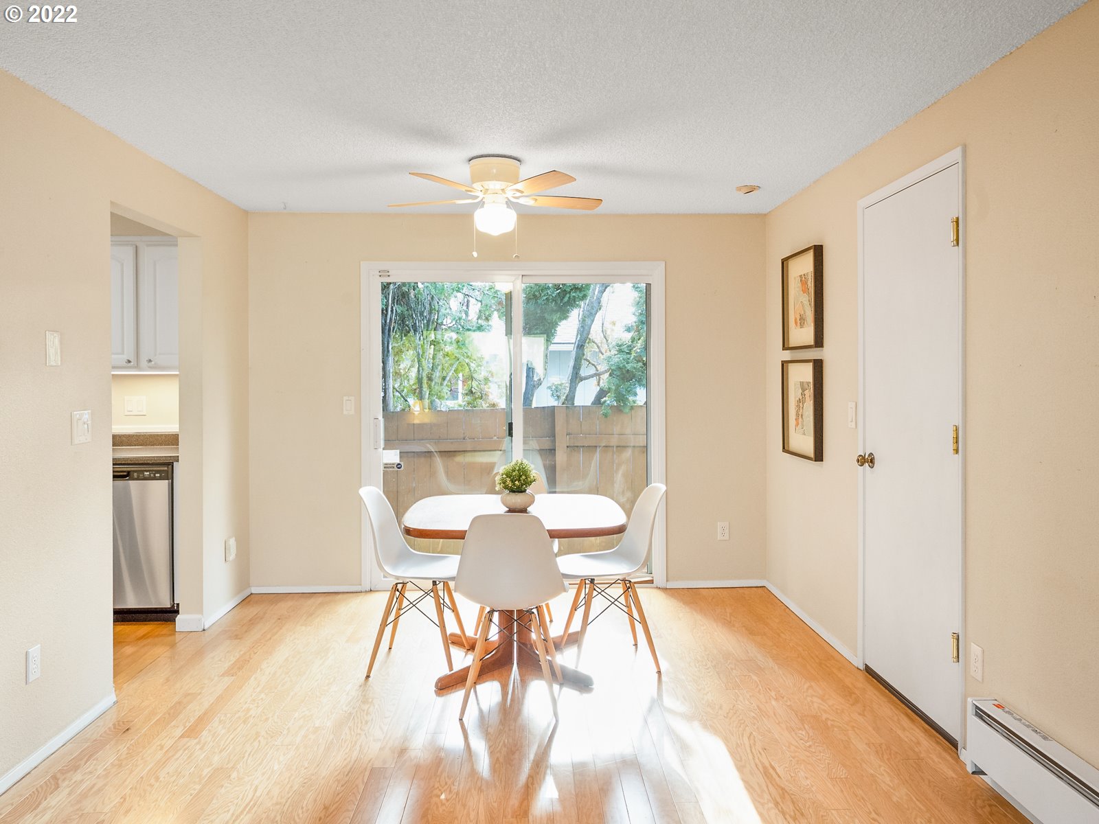 8810 Southeast Rural Street Portland, OR 97266 - Photo 7 of 32 a dining room with wooden floor and a chandelier
