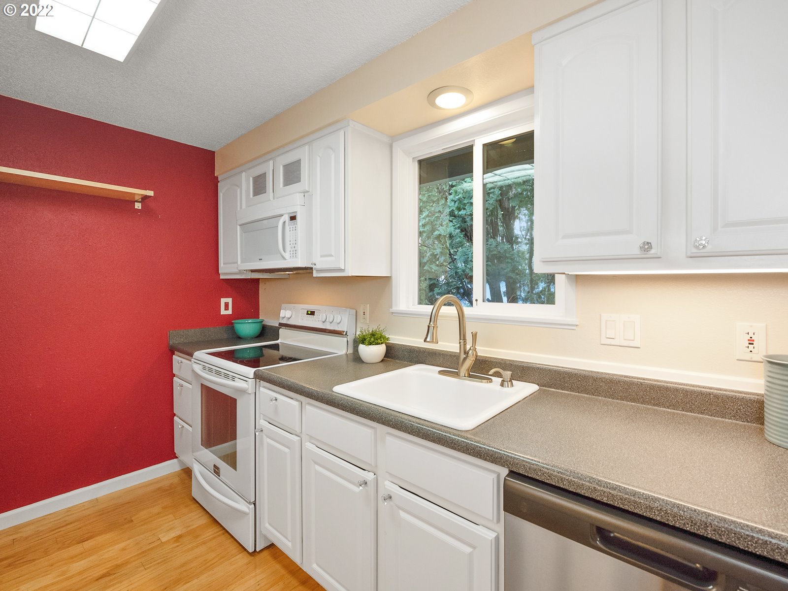 8810 Southeast Rural Street Portland, OR 97266 - Photo 9 of 32 a kitchen with a sink cabinets and window