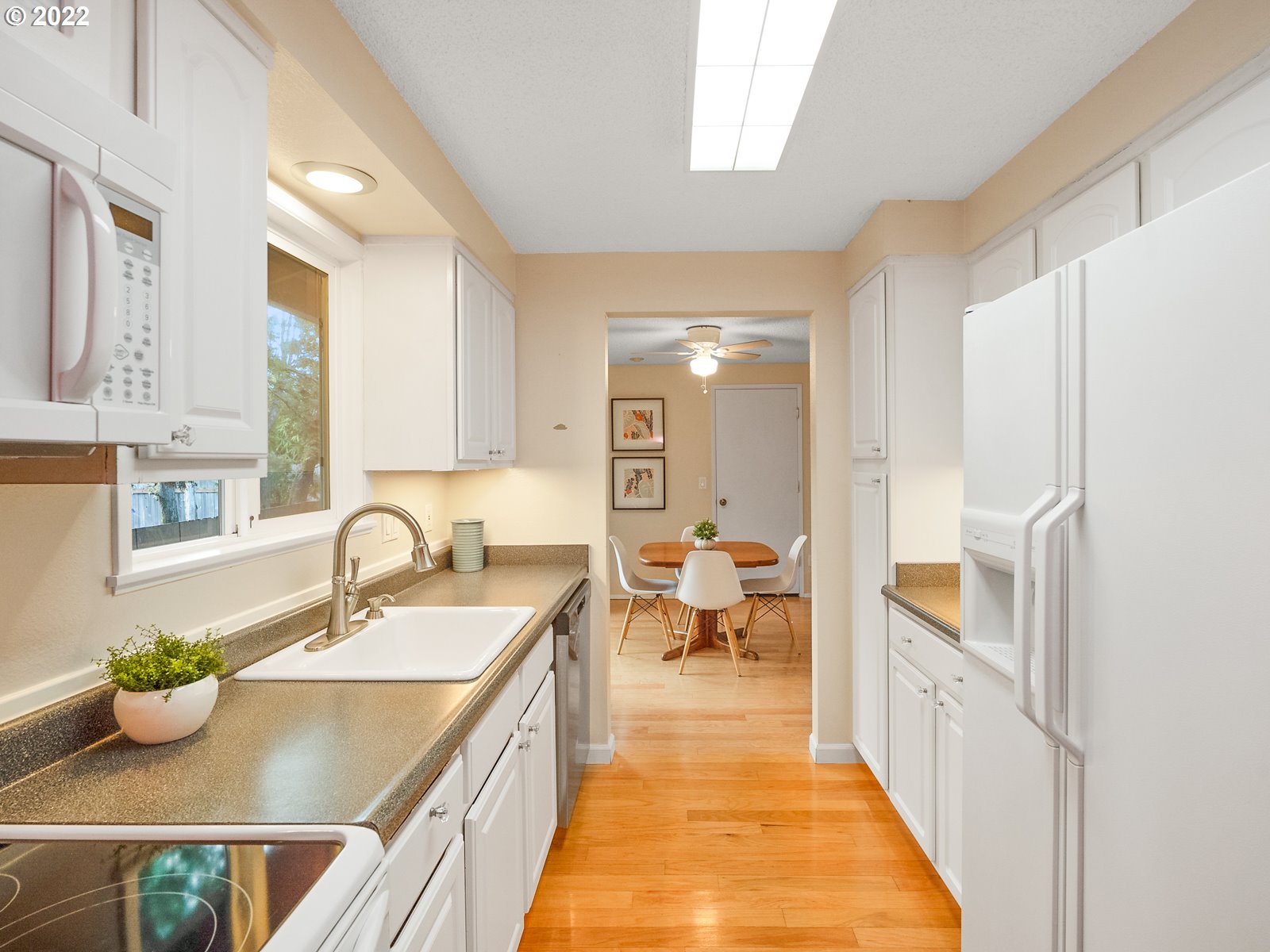 8810 Southeast Rural Street Portland, OR 97266 - Photo 10 of 32 a kitchen with a sink and living room