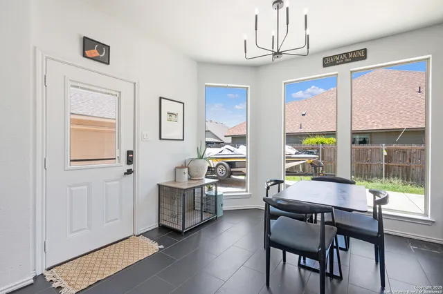 a dining room with furniture and window