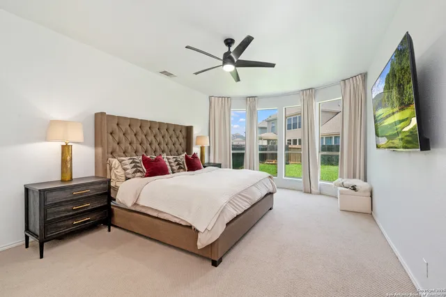 a large bed sitting in a room next to a window