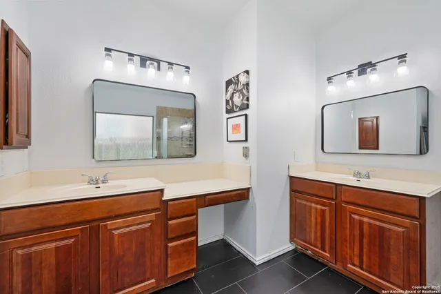 a bathroom with a double vanity sink and a mirror