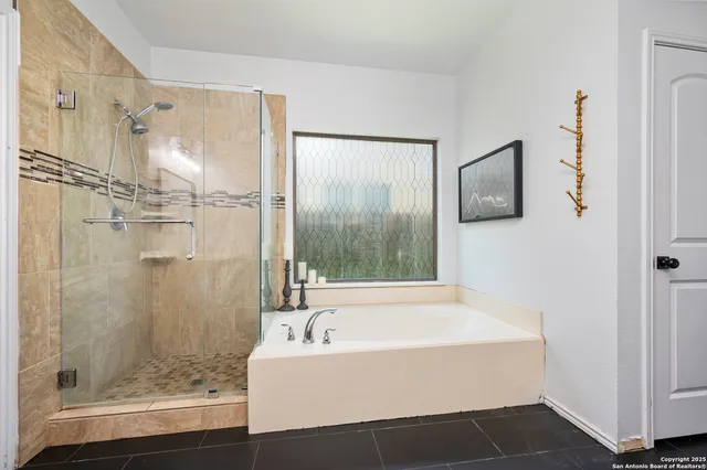 a bathroom with a bathtub and a shower