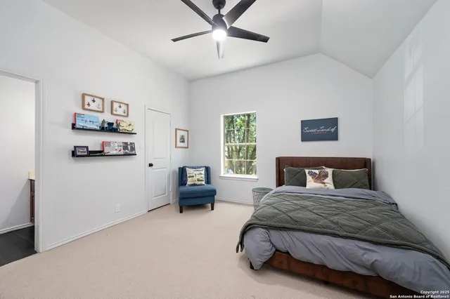 a bedroom with a bed couch and window