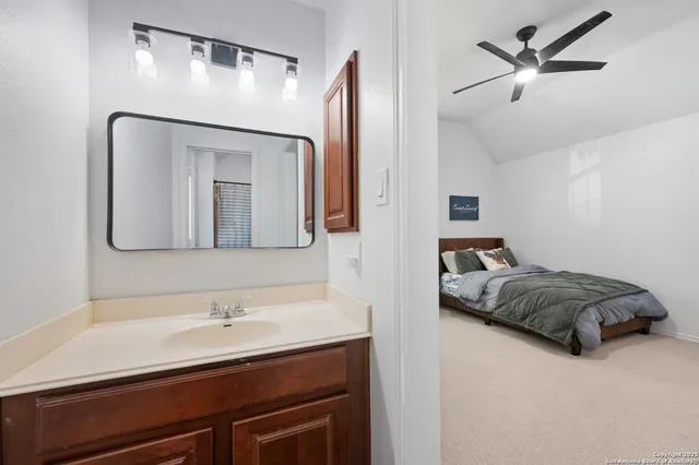 a en suite bathroom with a double vanity sink and a mirror