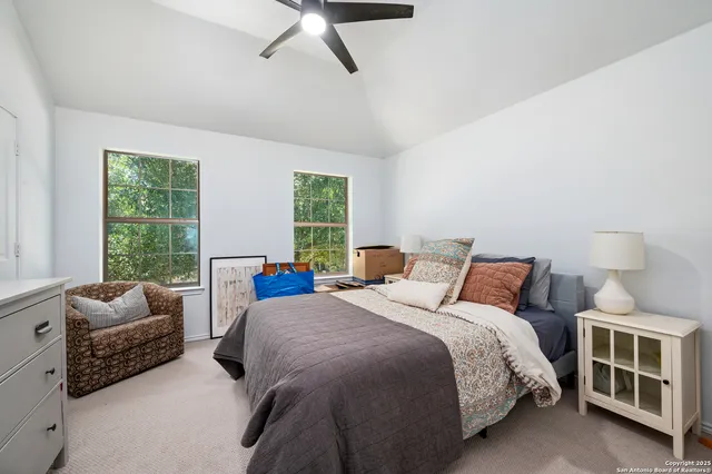 a bedroom with bed couch and window