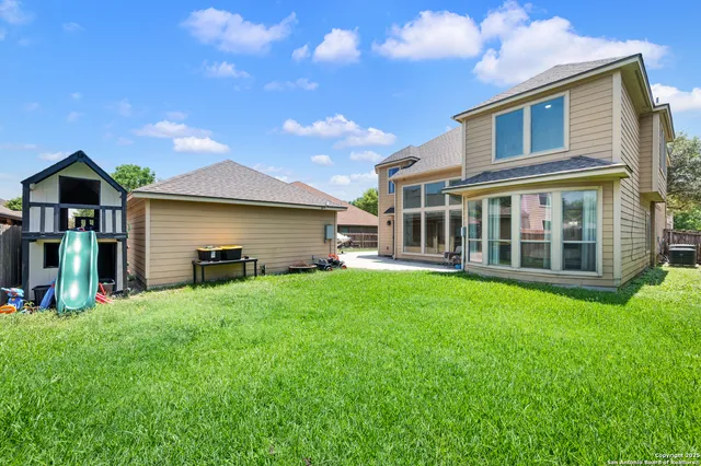 a view of a house with a yard and sitting area