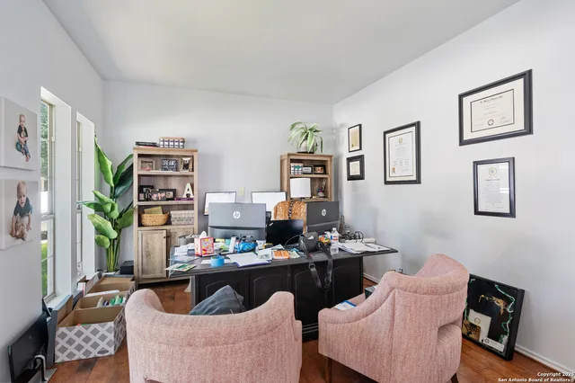 a living room with furniture potted plant and a window