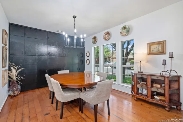 a dining room with furniture and wooden floor