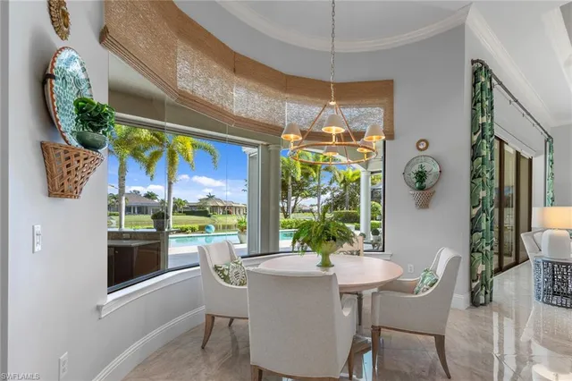 a dining room with furniture a chandelier and a rug