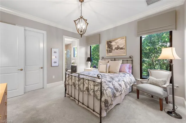 a bedroom with a bed and a chandelier