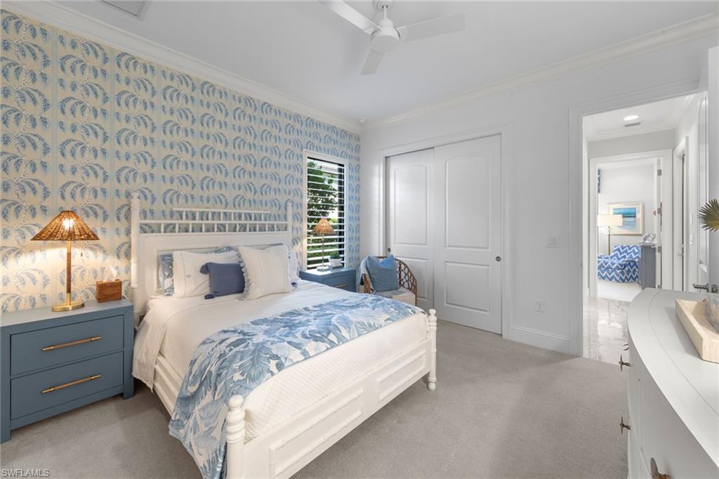 4170 Cortland Way Naples, FL 34119 - Photo 23 of 41 Bedroom featuring ornamental molding, a closet, wallpapered walls, light colored carpet, and ceiling fan