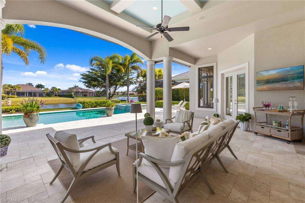 4170 Cortland Way Naples, FL 34119 - Photo 28 of 41 View of patio / terrace with an outdoor hangout area, french doors, a ceiling fan, a pool with connected hot tub, and a water view
