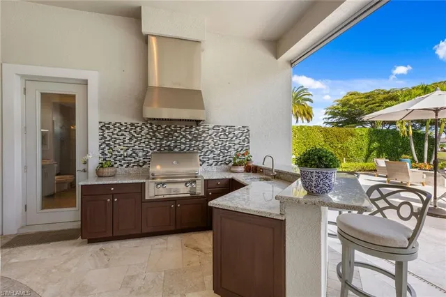 a kitchen with granite countertop a sink and a stove