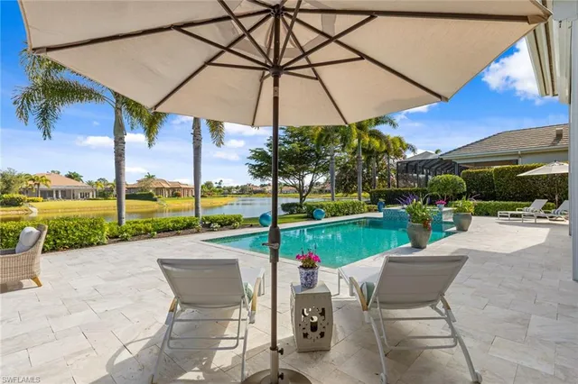 a view of a patio with a table and chairs under an umbrella