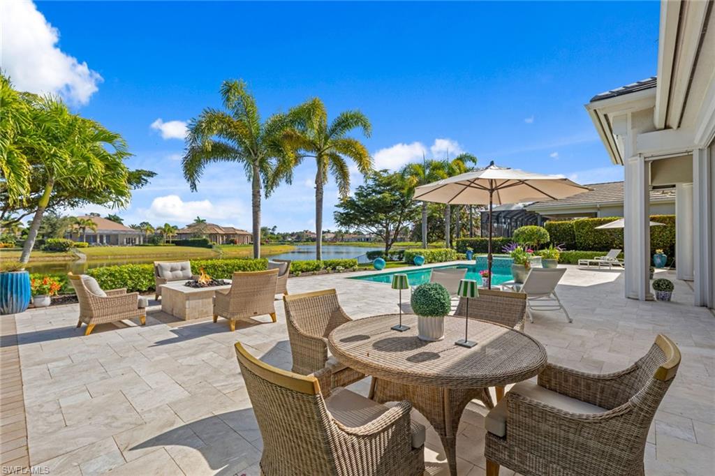 4170 Cortland Way Naples, FL 34119 - Photo 33 of 41 View of patio / terrace with an outdoor fire pit, an outdoor pool, a water view, and outdoor dining space