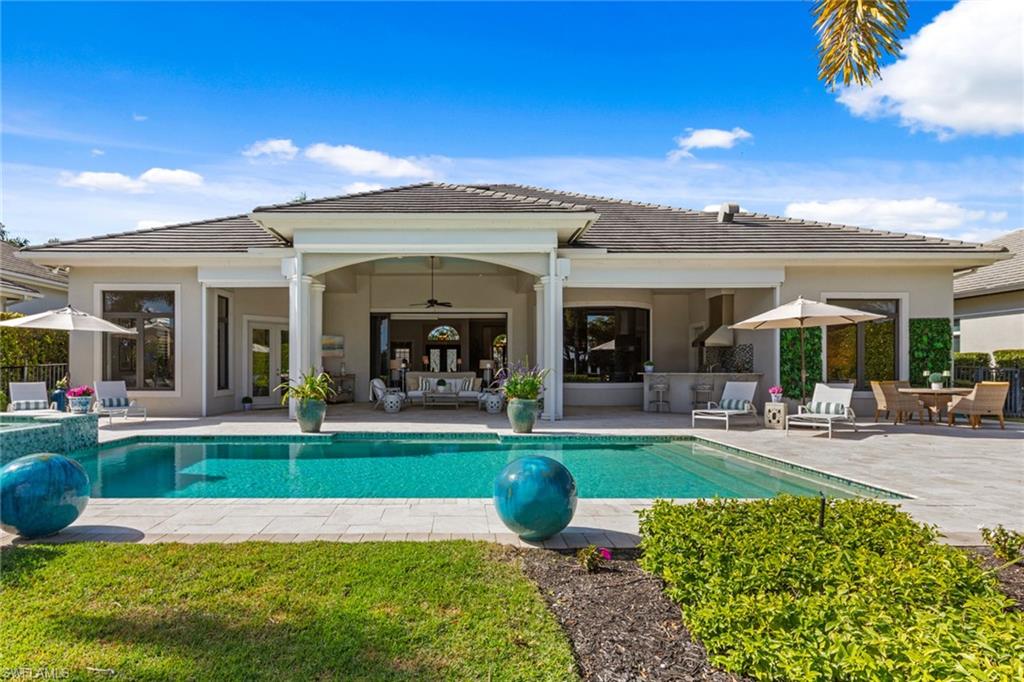 4170 Cortland Way Naples, FL 34119 - Photo 35 of 41 View of pool with a patio, outdoor lounge area, a pool with connected hot tub, and outdoor dining space