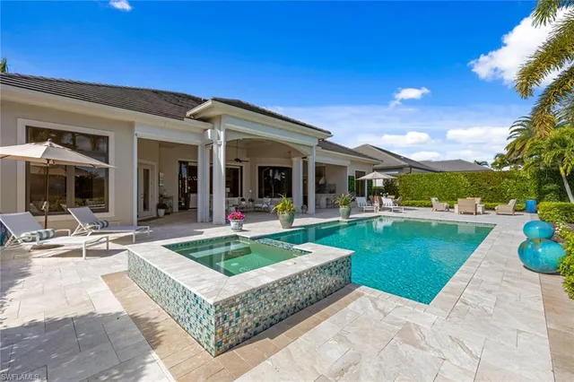 a view of a house with swimming pool and sitting area